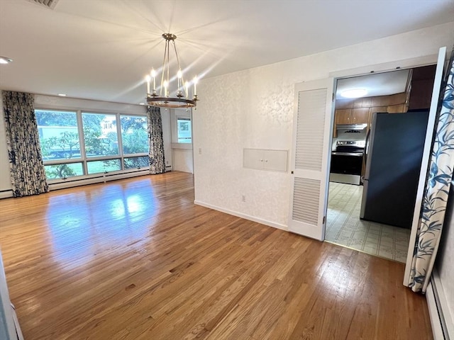 216 Bel Air Dr, Longmeadow, MA 01106 - unfurnished dining area featuring a chandelier, wood finished floors, and a baseboard heating unit