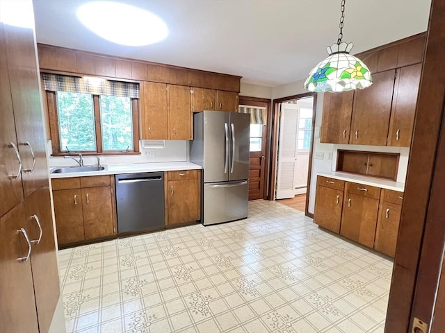 216 Bel Air Dr, Longmeadow, MA 01106 - kitchen with appliances with stainless steel finishes, light countertops, plenty of natural light, and brown cabinetry