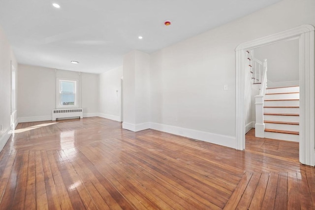 unfurnished room with wood-type flooring and radiator