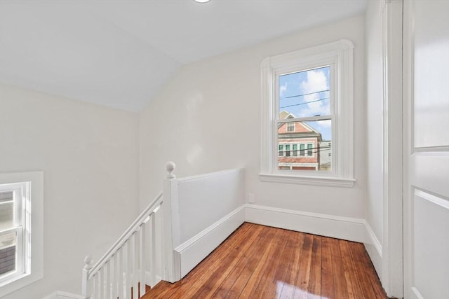 bonus room with vaulted ceiling and wood-type flooring