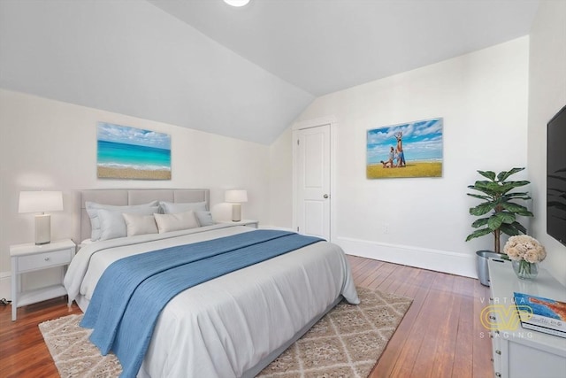 bedroom with lofted ceiling and hardwood / wood-style floors