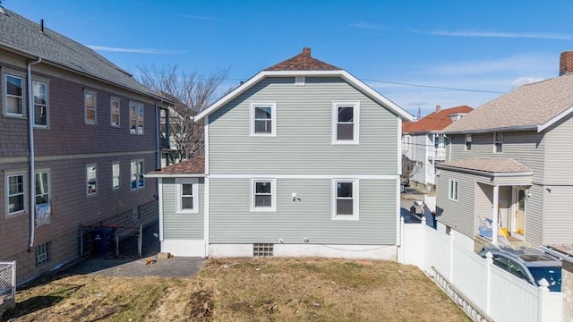 rear view of property with a yard