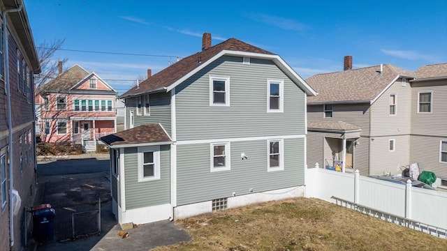 rear view of property featuring a yard