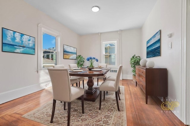 dining area featuring hardwood / wood-style flooring and a healthy amount of sunlight