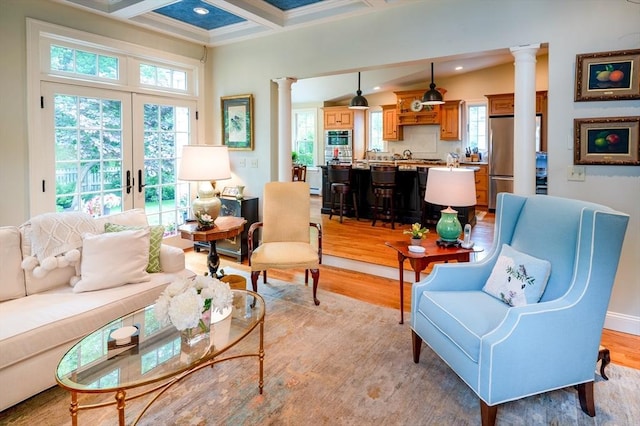9 Mohawk Rd, Marblehead, MA 01945 - living room with decorative columns, beamed ceiling, light wood-style flooring, coffered ceiling, and crown molding