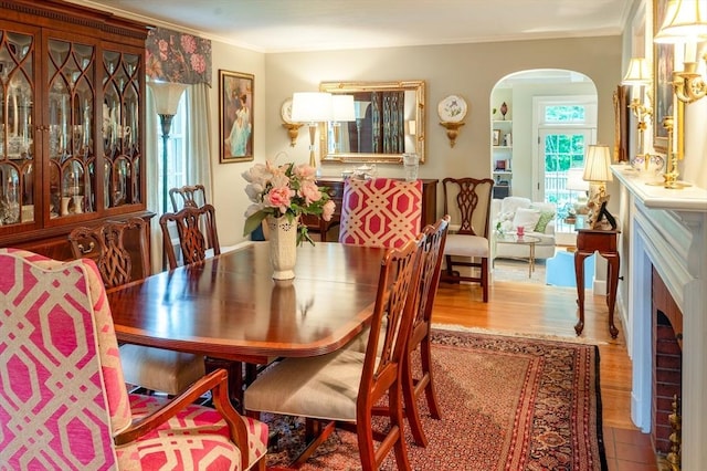 9 Mohawk Rd, Marblehead, MA 01945 - dining room featuring arched walkways, wood finished floors, and crown molding