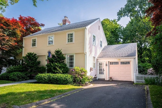 9 Mohawk Rd, Marblehead, MA 01945 - view of front of property with a chimney, an attached garage, and driveway