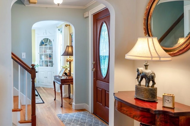 9 Mohawk Rd, Marblehead, MA 01945 - foyer featuring arched walkways, wood finished floors, stairs, and ornamental molding