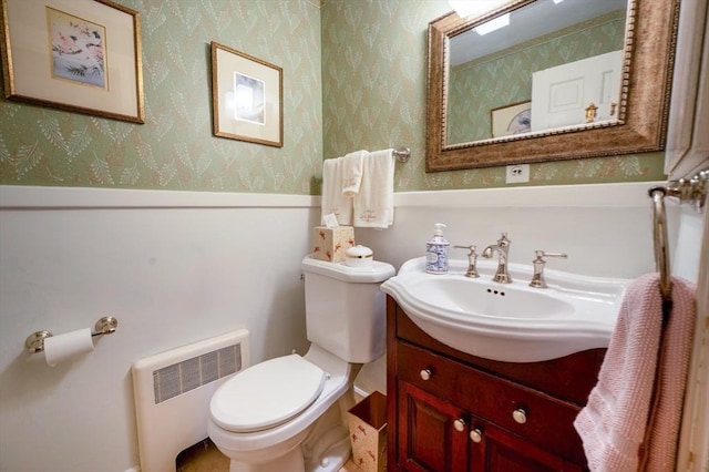 9 Mohawk Rd, Marblehead, MA 01945 - bathroom featuring radiator heating unit, wallpapered walls, vanity, and a wainscoted wall