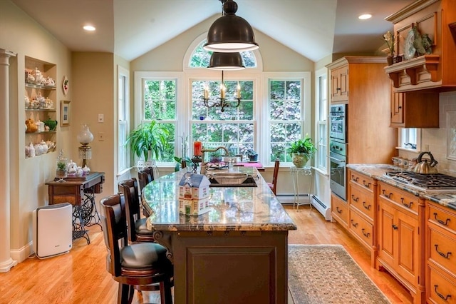 9 Mohawk Rd, Marblehead, MA 01945 - kitchen with appliances with stainless steel finishes, lofted ceiling, light wood-style floors, a breakfast bar, and light stone counters