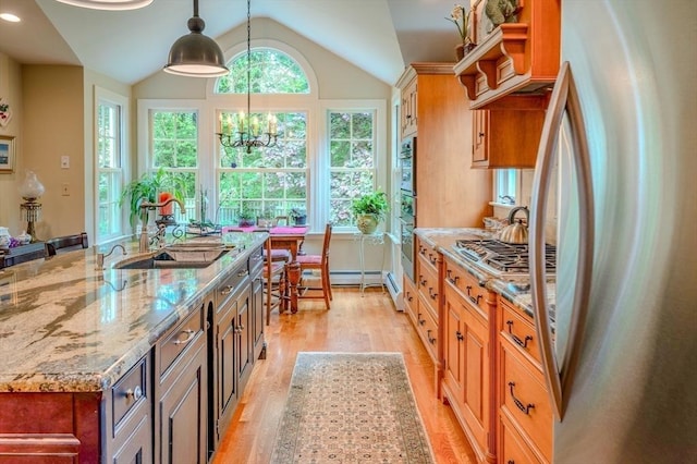 9 Mohawk Rd, Marblehead, MA 01945 - kitchen featuring stainless steel appliances, light wood-style floors, lofted ceiling, light stone countertops, and decorative light fixtures
