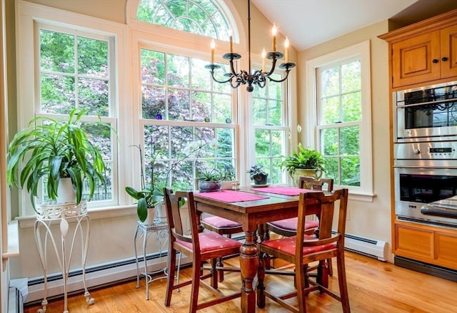 9 Mohawk Rd, Marblehead, MA 01945 - dining space featuring a baseboard radiator, a chandelier, lofted ceiling, light wood-type flooring, and plenty of natural light