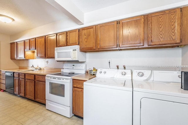 kitchen with sink, white appliances, and washer and dryer