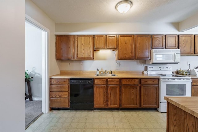 kitchen featuring sink and white appliances