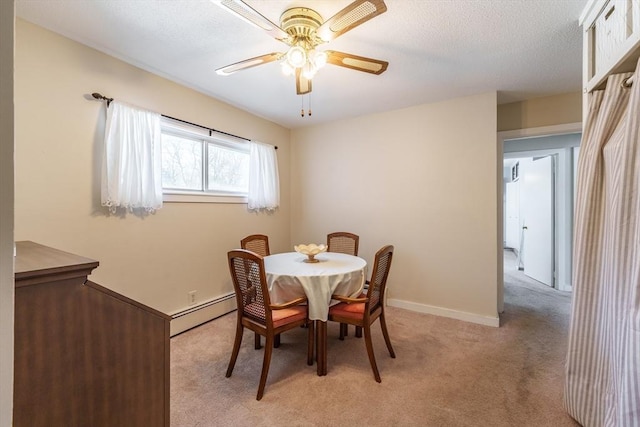 carpeted dining area with ceiling fan and a baseboard radiator