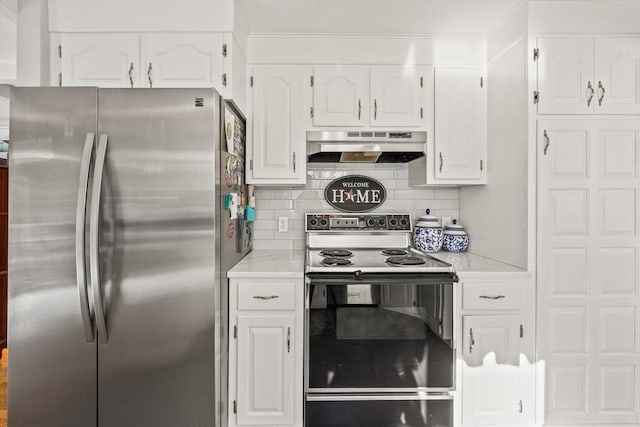 kitchen featuring range with electric stovetop, tasteful backsplash, freestanding refrigerator, white cabinets, and under cabinet range hood