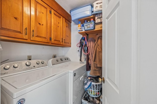 washroom with cabinet space and washing machine and clothes dryer