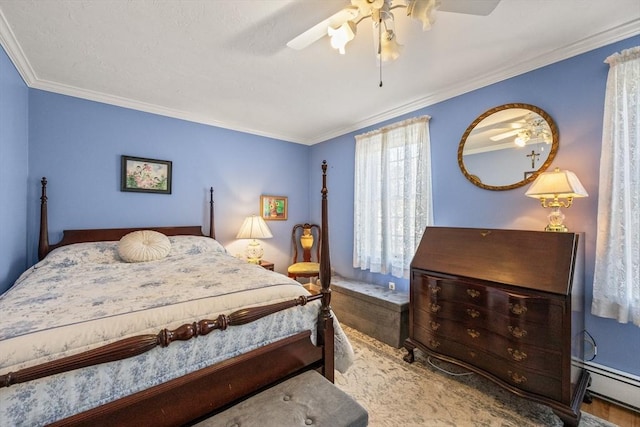 bedroom featuring ornamental molding, baseboard heating, and a ceiling fan