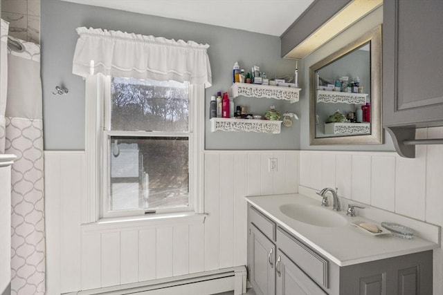 bathroom with a baseboard radiator, vanity, and wainscoting