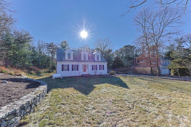 cape cod home with a front lawn