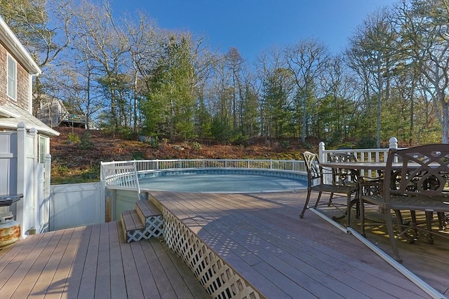 wooden terrace featuring outdoor dining space