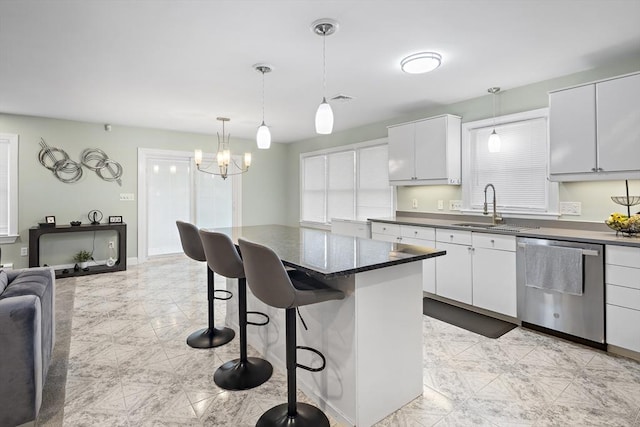 15 Bunker St Unit 2, Boston, MA 02136 - kitchen featuring stainless steel dishwasher, a sink, a breakfast bar area, and hanging light fixtures