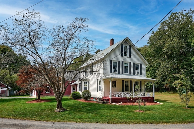 view of front of house featuring a front lawn and covered porch