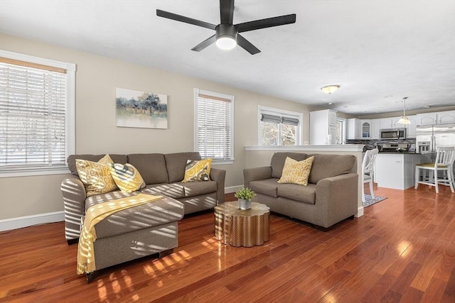 living room with dark hardwood / wood-style floors and ceiling fan