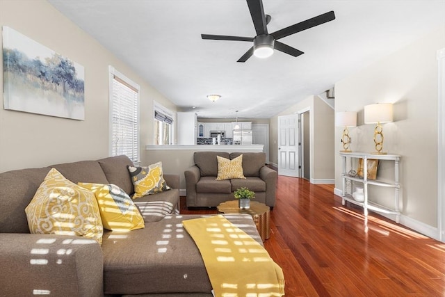 living room featuring ceiling fan and hardwood / wood-style floors