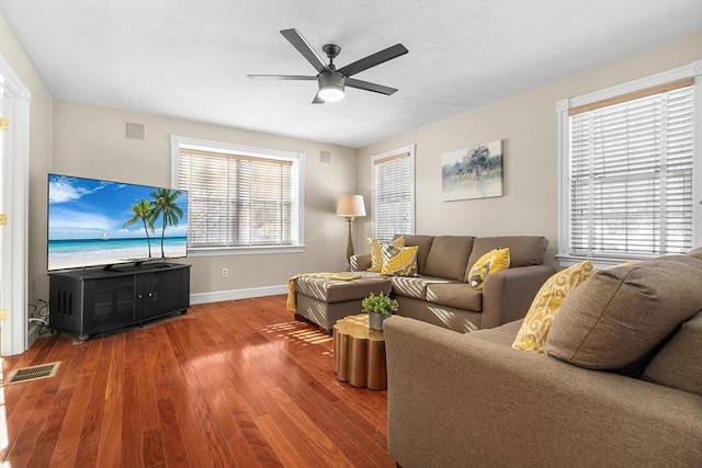 living room with hardwood / wood-style flooring, a wealth of natural light, and ceiling fan