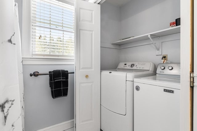 clothes washing area with washer and dryer