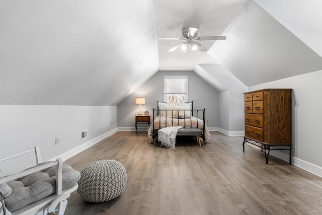 bedroom with vaulted ceiling, ceiling fan, and light hardwood / wood-style flooring