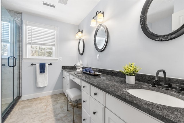 bathroom with vanity and a shower with shower door