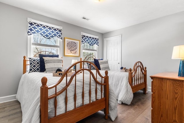 bedroom with dark hardwood / wood-style flooring