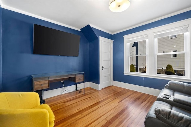 living room featuring crown molding and hardwood / wood-style flooring