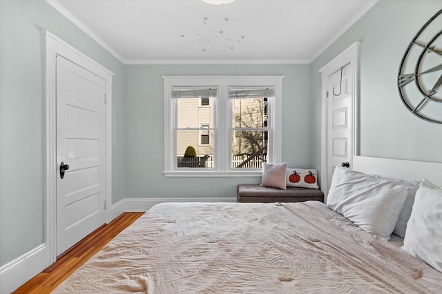 bedroom with light hardwood / wood-style flooring and ornamental molding