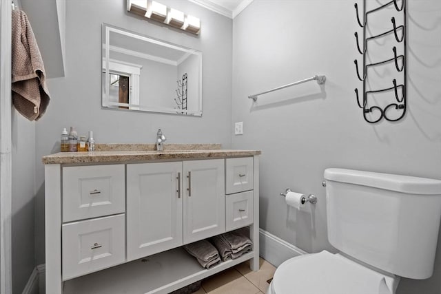 bathroom with tile patterned flooring, vanity, toilet, and ornamental molding