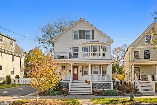 view of front of property featuring covered porch and a balcony