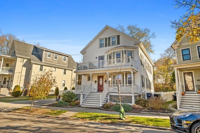 view of front of property featuring covered porch and a balcony