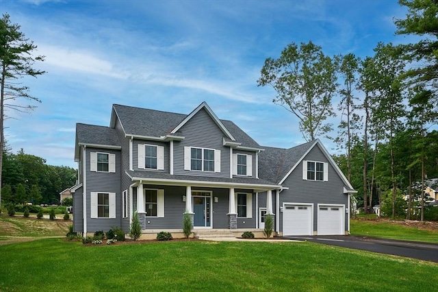 view of front of property with a shingled roof, a porch, aphalt driveway, and a front yard