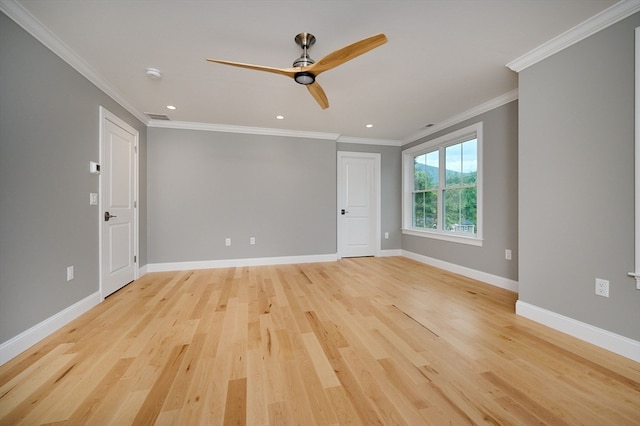 empty room featuring ceiling fan, ornamental molding, and light hardwood / wood-style flooring