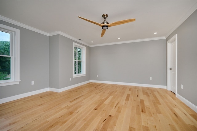 empty room with ceiling fan, plenty of natural light, and light hardwood / wood-style flooring