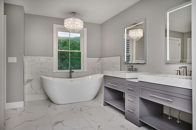 bathroom featuring a bathing tub, tile patterned flooring, vanity, a chandelier, and tile walls