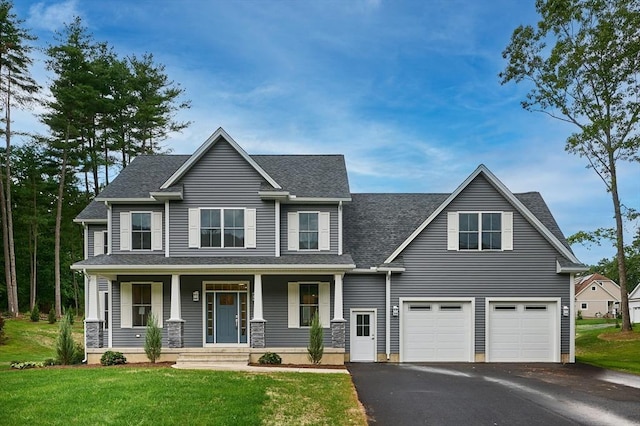 view of front facade with a shingled roof, aphalt driveway, an attached garage, a porch, and a front yard