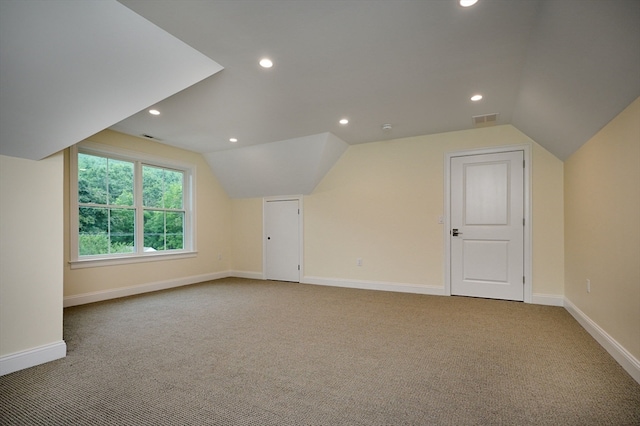 additional living space with lofted ceiling and carpet flooring