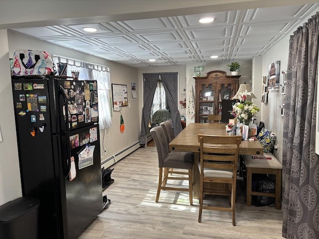 dining room with a baseboard heating unit, light wood-style flooring, recessed lighting, and an ornate ceiling