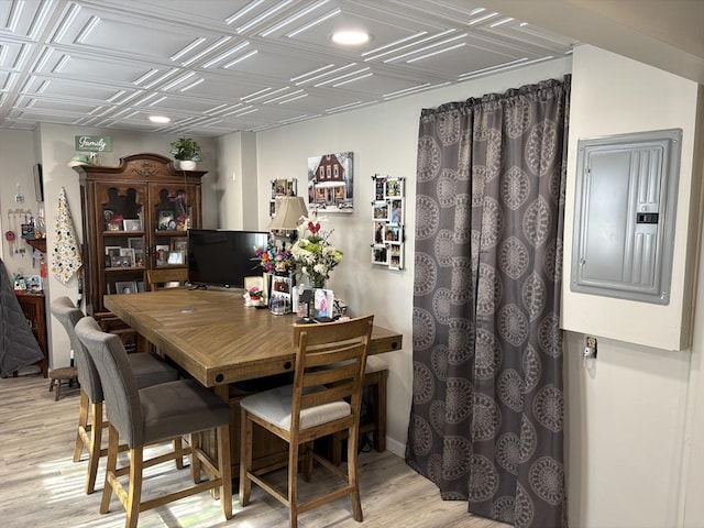 dining room with electric panel, recessed lighting, light wood finished floors, and an ornate ceiling