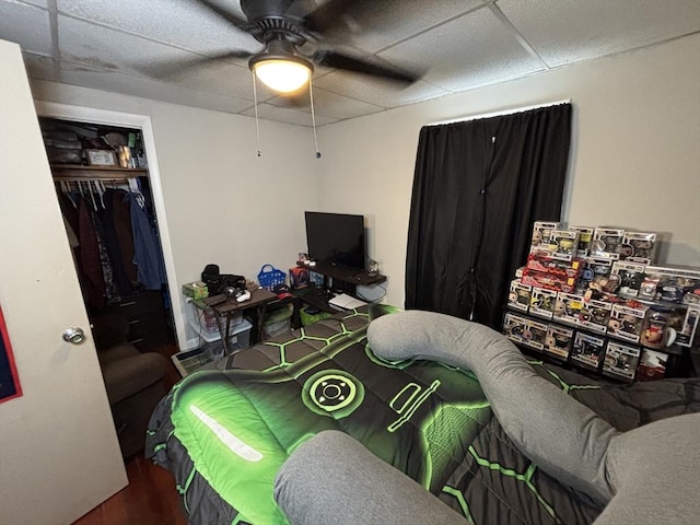 bedroom featuring a closet, a paneled ceiling, and ceiling fan