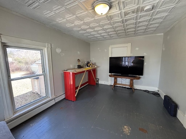 misc room with a baseboard radiator, an ornate ceiling, baseboards, and crown molding