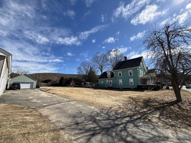 view of yard featuring an outbuilding and a garage